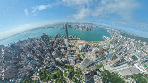 A 4k still video frame zooms out to reveal a breathtaking aerial view of Hong Kong's vibrant cityscape, showcasing its dense skyscrapers and surrounding harbor. photo