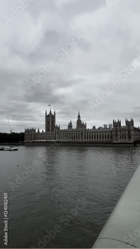 Big Ben and Westminster Bridge with Houses of Parliament from far away in gloomy day. London, South England.
Big Ben and Westminster Bridge with Houses of Parliament while a boat crossing by
