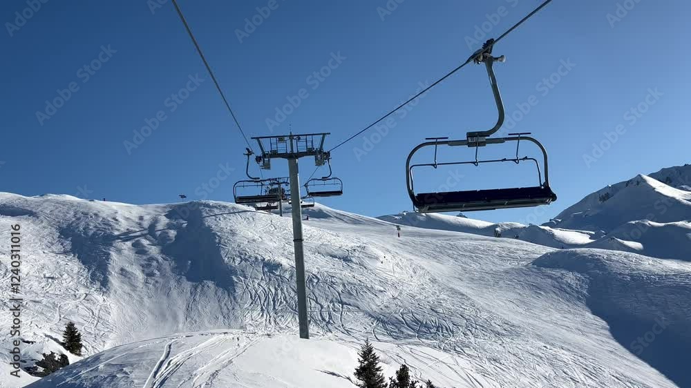 Ski lift over the slopes of Courchevel ski resort by winter Ski lift over the slopes of Courchevel ski resort by winter
