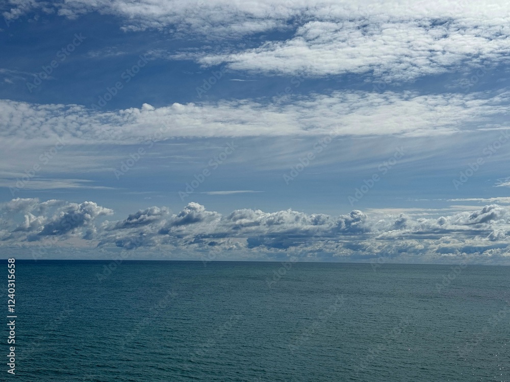 Scenic clouds over calm blue ocean. Scenic clouds over calm blue ocean.