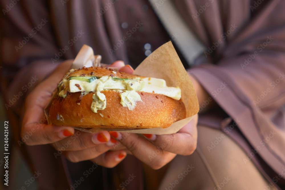 Savory pastry held by a person in a cozy setting Savory pastry held by a person in a cozy setting