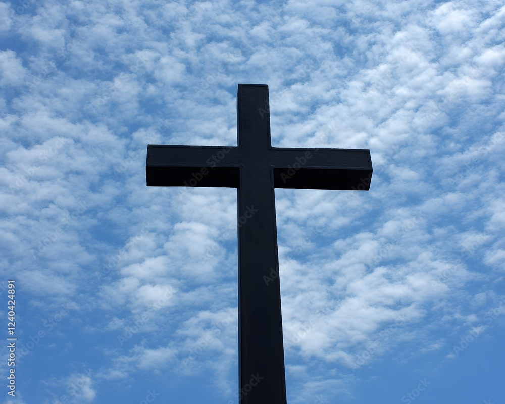 Large Black Cross Against Blue Sky with Clouds, Religious Symbol Image Large Black Cross Against Blue Sky with Clouds, Religious Symbol Image