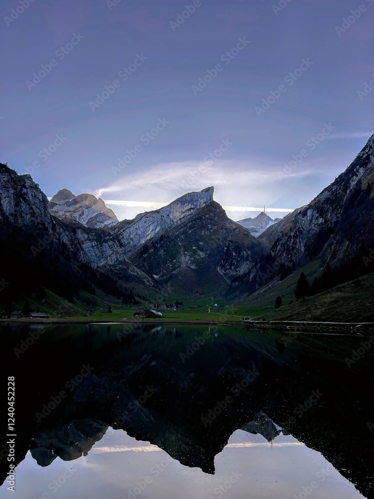 Fototapeta premium Magic photo of a lake reflecting the mountains during a hike in the Swiss Alps