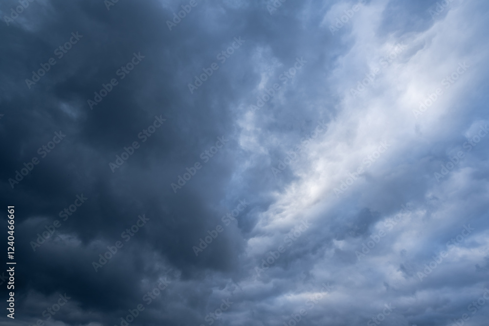 A captivating and breathtaking view of a stormy sky that is filled with ominous dark clouds alongside lighter patches, evoking a sense of awe at natures sheer and unyielding power A captivating and breathtaking view of a stormy sky that is filled with ominous dark clouds alongside lighter patches, evoking a sense of awe at natures sheer and unyielding power