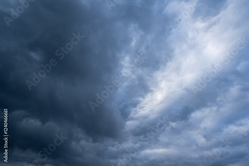 A captivating and breathtaking view of a stormy sky that is filled with ominous dark clouds alongside lighter patches, evoking a sense of awe at natures sheer and unyielding power photo