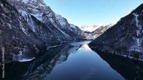 Wallpaper Mural Aerial captures the breathtaking beauty of the Klöntalersee in Switzerland. The lake stretches out like a ribbon between towering, snow-capped mountains. Torontodigital.ca
