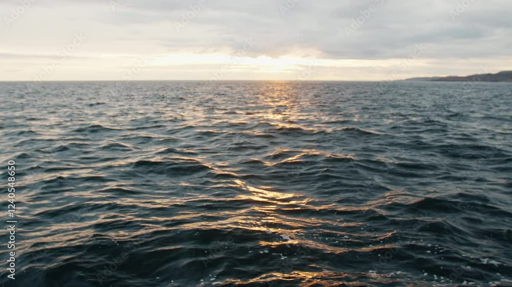 Dark ocean waves reflecting golden sunset light Dark ocean waves reflecting golden sunset light