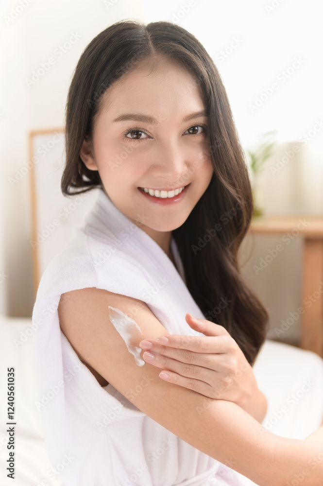Young beautiful Asian woman applying skin care cream lotion on her arm. Woman beauty selfcare cosmetic caring routine concept. Young beautiful Asian woman applying skin care cream lotion on her arm. Woman beauty selfcare cosmetic caring routine concept.