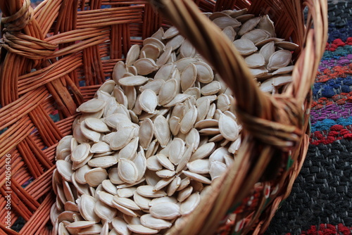 Old wicker wooden basket with pumpkin seeds.