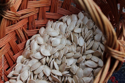 Old wicker wooden basket with pumpkin seeds.