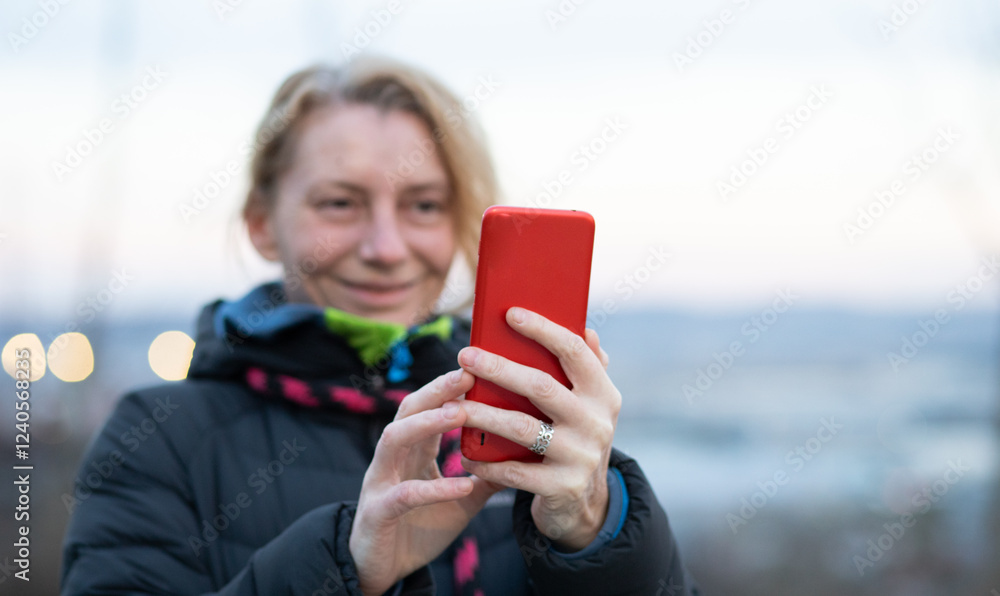 Fototapeta premium woman using her phone outdoors
