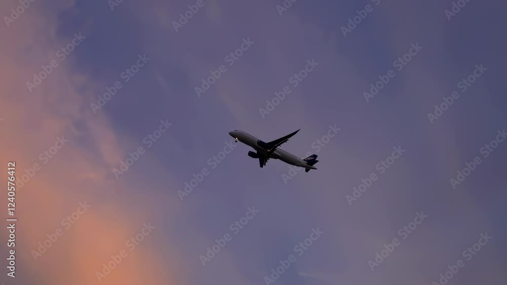 Airplane soars through the sky during sunset, casting shadows against the vibrant backdrop of colorful clouds. The peaceful landscape below creates a serene atmosphere. Airplane soars through the sky during sunset, casting shadows against the vibrant backdrop of colorful clouds. The peaceful landscape below creates a serene atmosphere.