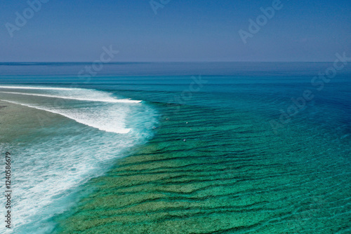 Aerial view of beautiful turquoise ocean with serene waves and unspoiled reef, Baa Atoll, Maldives. photo