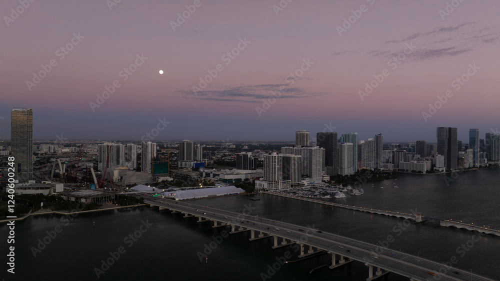 Aerial view of downtown skyline with skyscrapers and moon over Bayfront Park, Miami, United States. Aerial view of downtown skyline with skyscrapers and moon over Bayfront Park, Miami, United States.