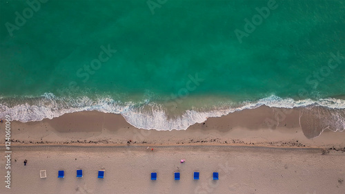 Aerial view of abstract beach with sun loungers and waves, Miami Beach, United States. photo