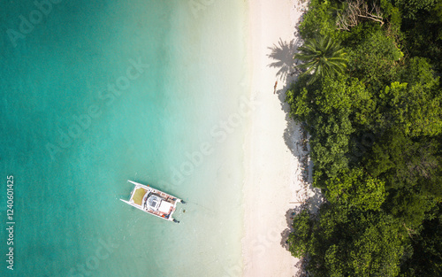 Aerial view of tropical paradise beach with turquoise ocean and lush greenery, Mueang Satun, Thailand. photo