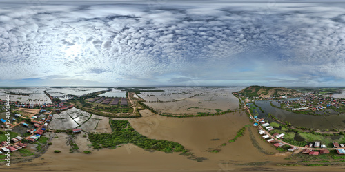 Aerial view of serene wetlands with traditional village and lush greenery, Chong Khnies, Cambodia. photo