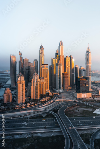 Dubai, United Arab Emirates - 14 February 2022: Aerial view of dubai marina skyline with modern skyscrapers and busy highway at sunset, Dubai, United Arab Emirates. photo