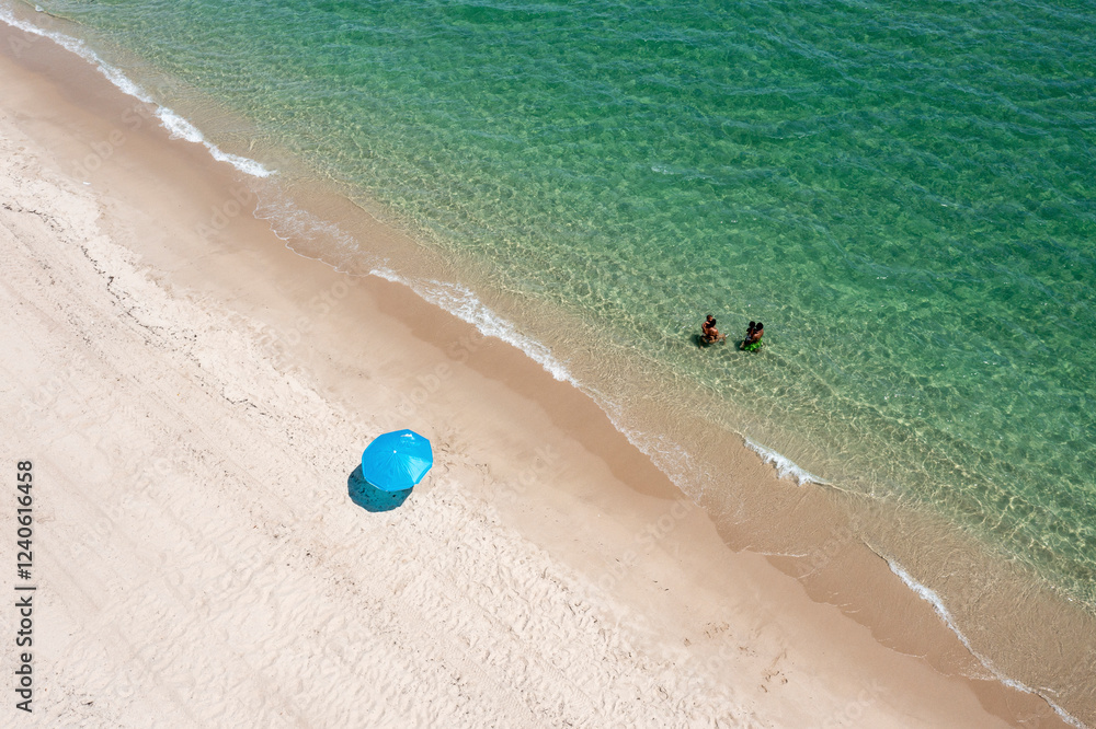 Aerial view of a beautiful sandy beach with colorful parasols and umbrellas, Florida, United States. Aerial view of a beautiful sandy beach with colorful parasols and umbrellas, Florida, United States.
