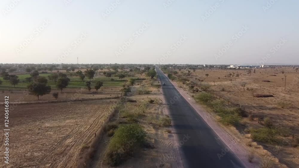 Drone view of a national highway in India with desert on both sides Drone view of a national highway in India with desert on both sides