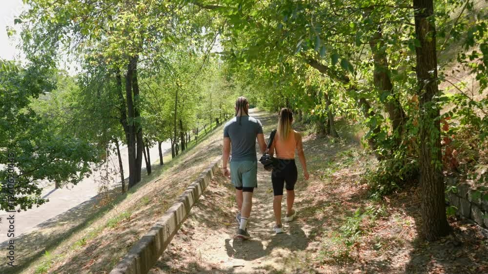 Active young couple in sportswear enjoying an outdoor walk. Active young couple in sportswear enjoying an outdoor walk.