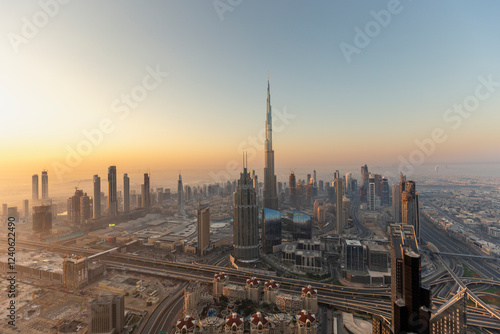 Aerial view of burj khalifa towering over the beautiful cityscape at sunset, dubai, united arab emirates.