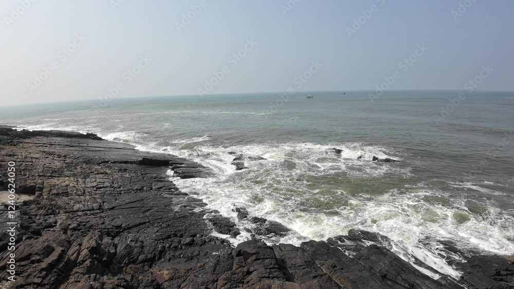Ocean Waves Crashing On The Big Black Rocks On The Seashore Ocean Waves Crashing On The Big Black Rocks On The Seashore