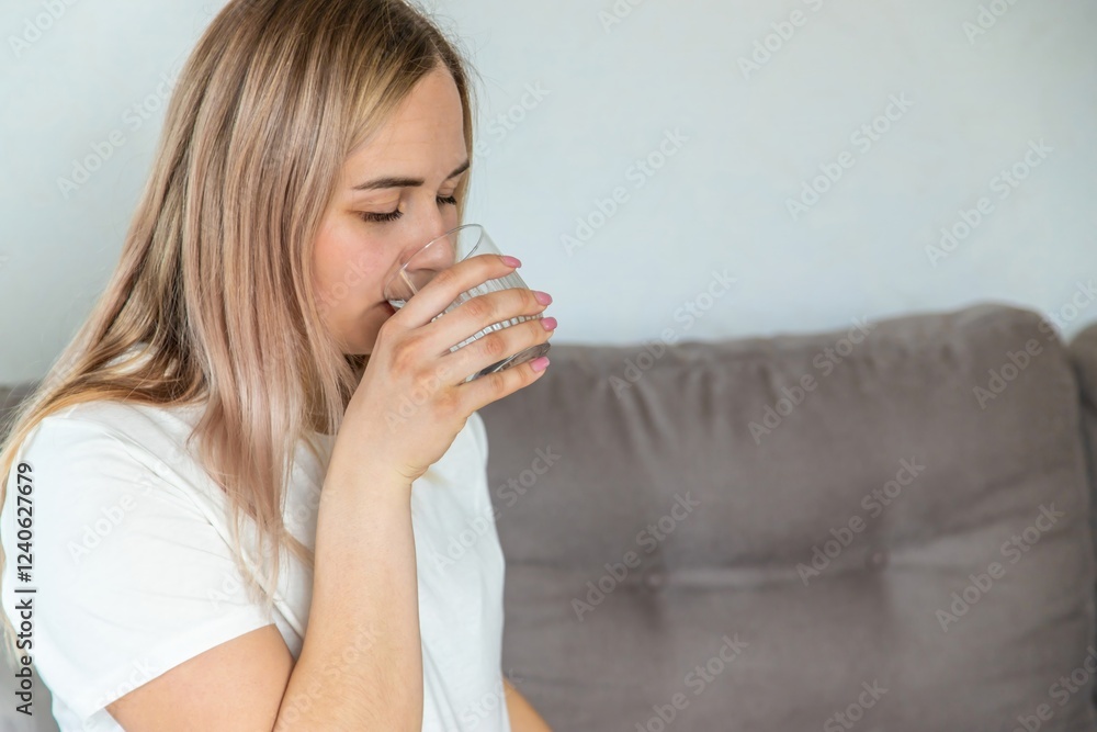 A pregnant woman drinks water. Selective focus. A pregnant woman drinks water. Selective focus.