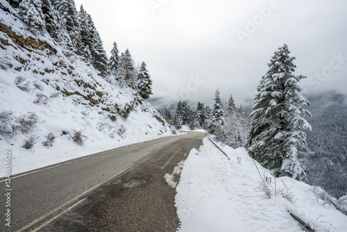 Asphalt road through the mountain with snow