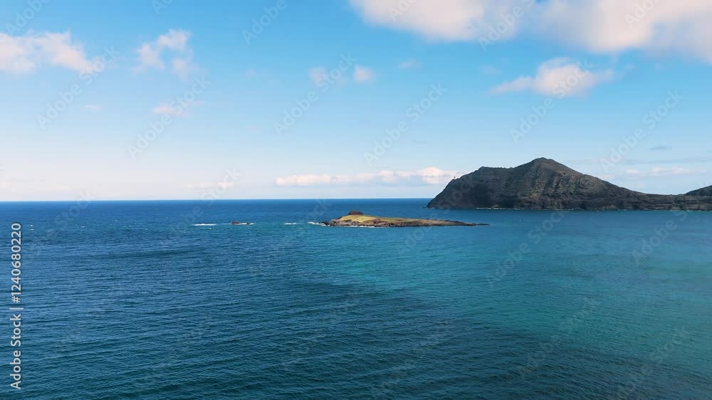 Aerial view of beautiful tranquil ocean and coastline with clear blue sky and clouds, Waimanalo, United States. Aerial view of beautiful tranquil ocean and coastline with clear blue sky and clouds, Waimanalo, United States.