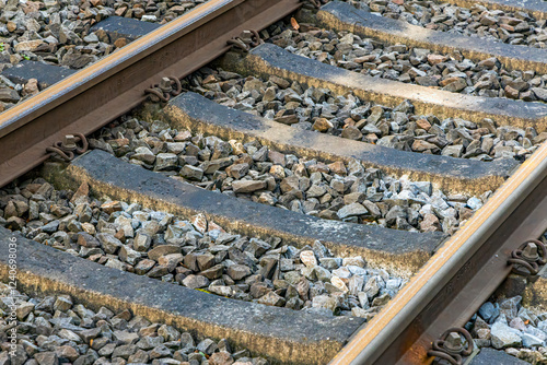Railway track with gravel in the train station, closeup of photo