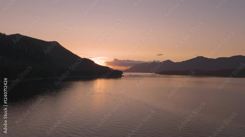 Aerial view of serene sunset over tranquil lake surrounded by majestic mountains and calm sky, Sitka, United States. Aerial view of serene sunset over tranquil lake surrounded by majestic mountains and calm sky, Sitka, United States.