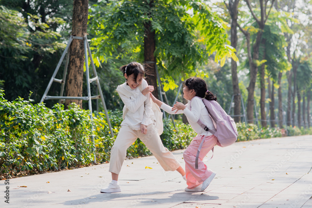 Fototapeta premium Two sisters go to school together 