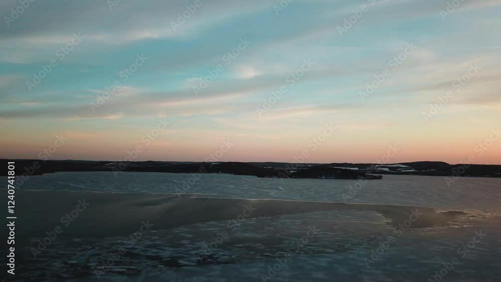 A serene winter landscape featuring a frozen lake at sunset, with icy formations and a colorful sky reflecting on the surface. A serene winter landscape featuring a frozen lake at sunset, with icy formations and a colorful sky reflecting on the surface.