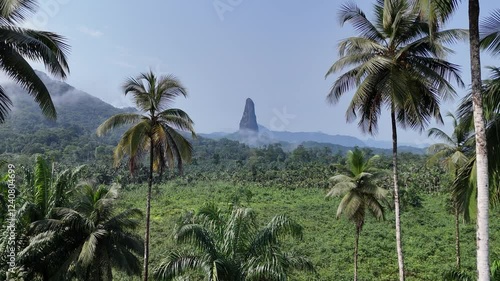 Sao Tome and Principe - Aerial View of Pico Cao Grande. Iconic Volcanic Needle Rising Above Lush Tropical Rainforest. View From Praia Grande. 