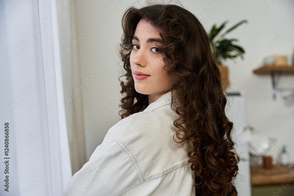 Captivating young woman with curly hair enjoying cozy moments at home Captivating young woman with curly hair enjoying cozy moments at home
