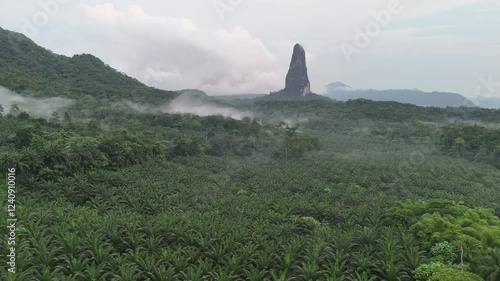 Sao Tome and Principe - Aerial View of Pico Cao Grande. Majestic Volcanic Needle Towering Over Dense Tropical Rainforest.