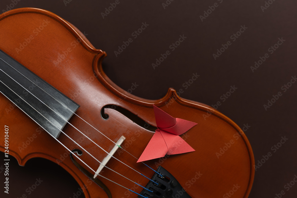 A paper butterfly on a wooden violin, representing the beauty of creativity and liberty. Creative, music, and innovation themes. A paper butterfly on a wooden violin, representing the beauty of creativity and liberty. Creative, music, and innovation themes.