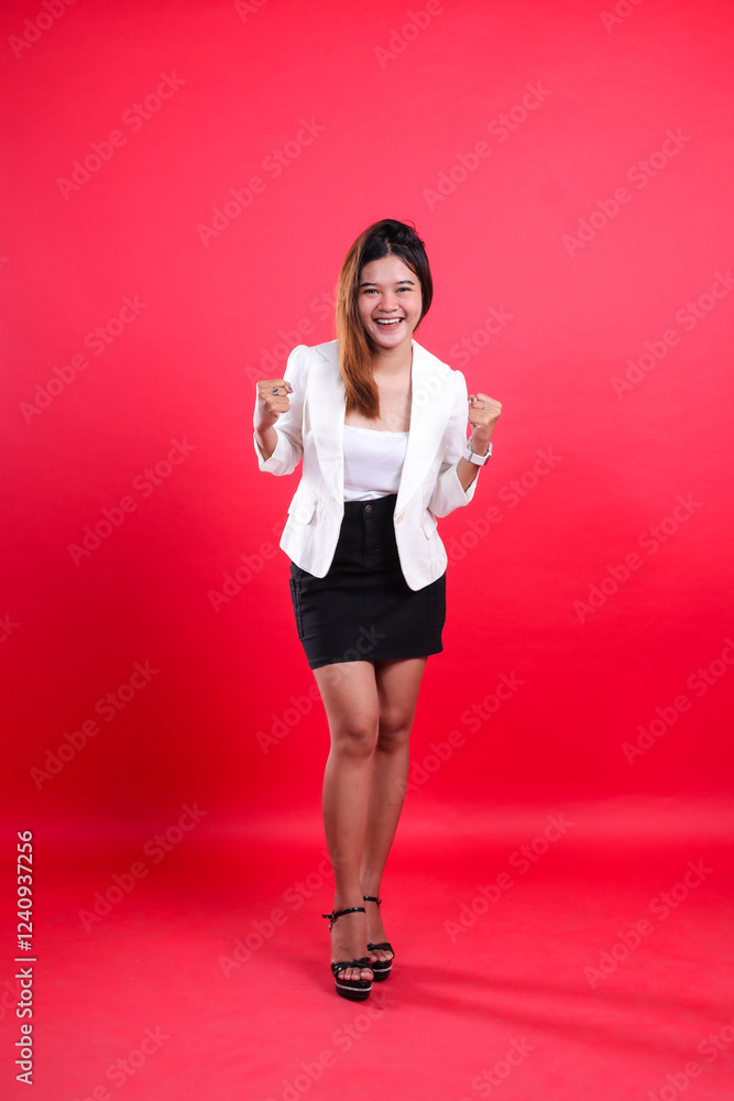 full length asian office girl wearing white coat cheerful both hands celebration clenched forward, standing isolated red background. for corporate, business, fashion, beauty content full length asian office girl wearing white coat cheerful both hands celebration clenched forward, standing isolated red background. for corporate, business, fashion, beauty content