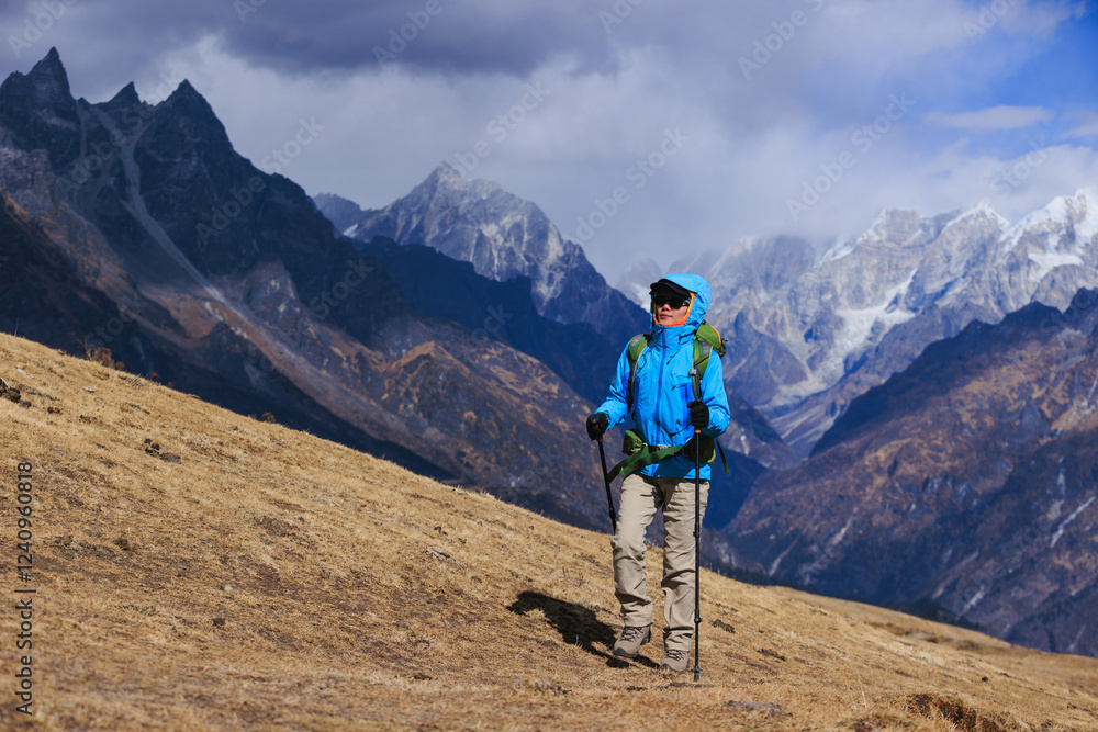 Fototapeta premium Backpacking woman hiking on high altitude mountain top