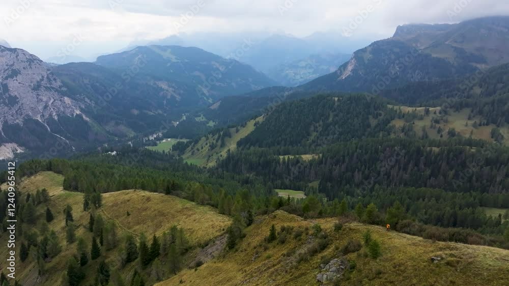 Aerial view of col de la puina with a hiker in a majestic mountainous landscape, Borca di Cadore, Italy. Aerial view of col de la puina with a hiker in a majestic mountainous landscape, Borca di Cadore, Italy.