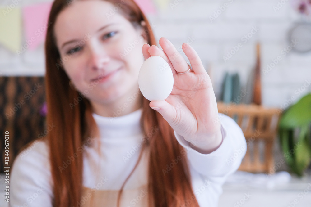 woman holding white easter egg , getting ready for Easter woman holding white easter egg , getting ready for Easter