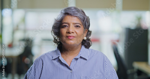 Indian Asian gen x old aged older woman lady look cam do work talk chat share idea new plan online video call office head shot view elder adult expert female speak make vlog shoot day blog job place