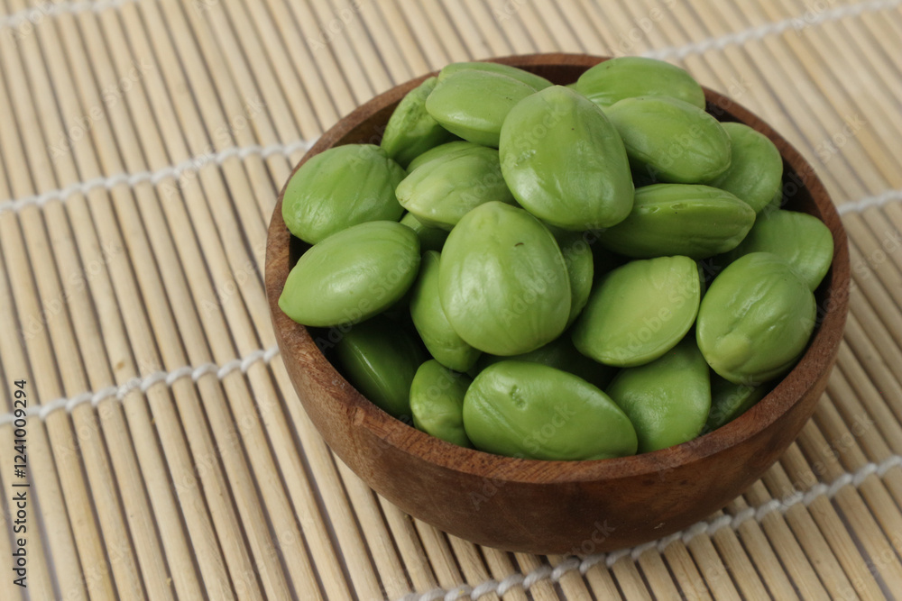Delicious and Aromatic Parkia Speciosa (Petai) Beans in a Wooden Bowl Delicious and Aromatic Parkia Speciosa (Petai) Beans in a Wooden Bowl