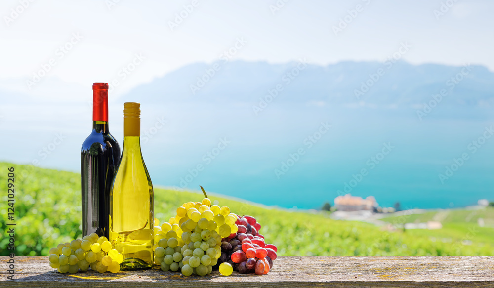 Fototapeta premium A basket filled with various types of grapes and bottles of red and white wine
