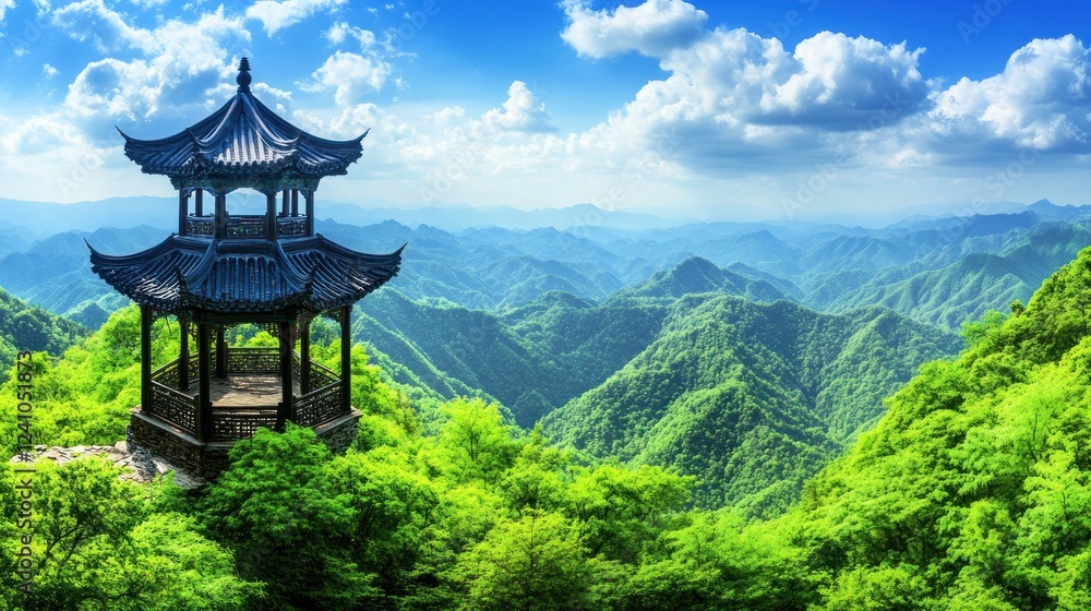 Panoramic view of a traditional Chinese pavilion atop lush green mountains under a vibrant blue sky. Panoramic view of a traditional Chinese pavilion atop lush green mountains under a vibrant blue sky.
