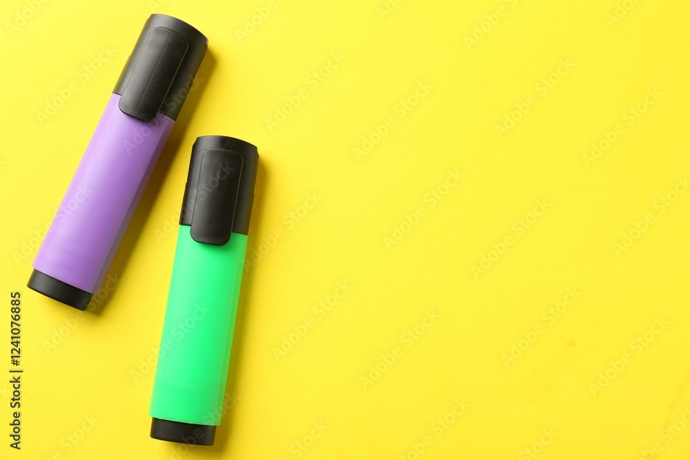 Bright highlighters on yellow background, flat lay. Space for text Bright highlighters on yellow background, flat lay. Space for text