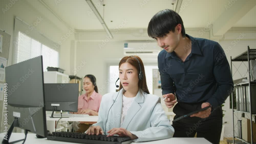 A team collaborates in an office setting, Businesswoman interacting with a colleague. Boss and leadership help. Men with technology, Callcenter, Cheerful asian business woman discussing project A team collaborates in an office setting, Businesswoman interacting with a colleague. Boss and leadership help. Men with technology, Callcenter, Cheerful asian business woman discussing project