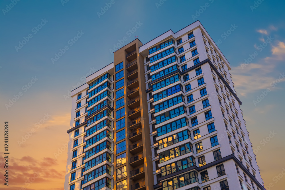 Fototapeta premium Modern buildings, walls and windows, reflections and sun rays. City view on a sunny day. 