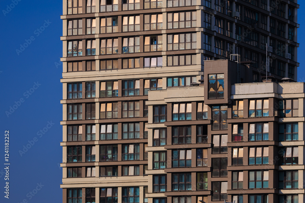 Modern buildings, walls and windows, reflections and sun rays. City view on a sunny day. Modern buildings, walls and windows, reflections and sun rays. City view on a sunny day.